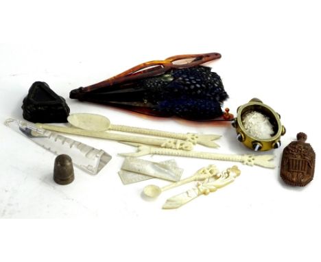 A collection of items, to include bone utensils, a glass obelisk and stand, small fan with feathers, and an agate pendant ins