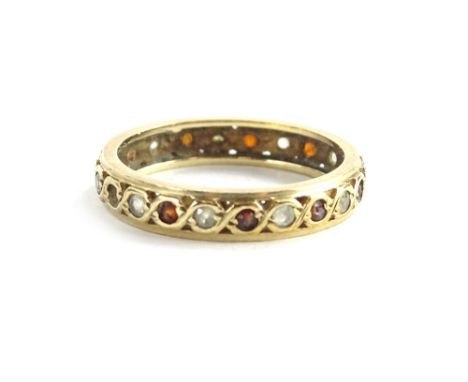 A yellow metal diamond ruby eternity ring, unmarked, 2.7g all in.