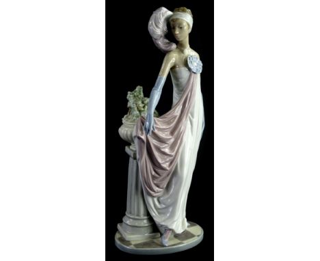A Lladro figure, of a lady in flowing robes aside pillar, impressed and printed marks beneath, 33cm H.