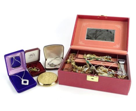 A red faux leather jewellery box and contents, comprising dress rings, modern wristwatches, portrait brooches, compact, neckl