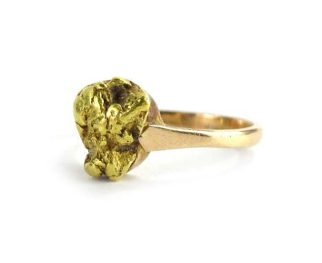 A golden nugget dress ring, the central nugget design, on a later plain band, yellow metal, stamped 15k, ring size L, 3.7g al