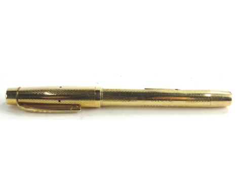 An Onoto gold plated fountain pen, with engine turned decoration.
