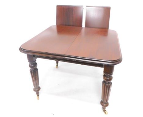 A Victorian and mahogany extending dining table, the rectangular top with a moulded edge , one loose leaf on turned fluted le