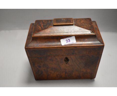 A Victorian tea caddy of casket form with burr yew wood veneered case and double compartment both with lids. Missing escutche