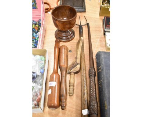 A selection of treen wood items including a knitting stick, distaff, clubs and a toasting fork