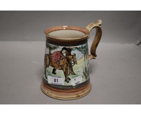 A large ceramic tankard hand decorated with a fox hunting scene