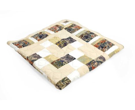 A patchwork quilt, circa 1999, by Mary Godfrey, worked in various printed and dyed fabrics, 145 x 145cm