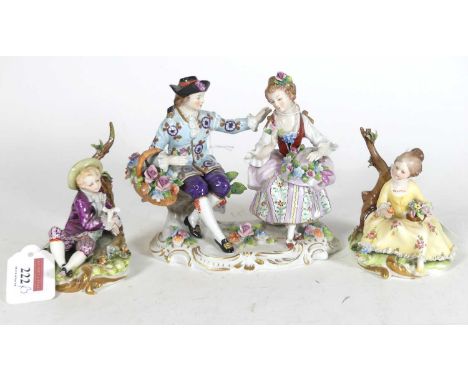 A Sitzendorf porcelain figure group of a courting couple, modelled seated on a floral encrusted base, printed blue mark to th