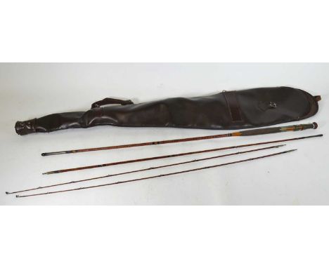 An early 20th century bamboo split cane fishing rod, in three sections, with canvas case; together with various reels, hook, 