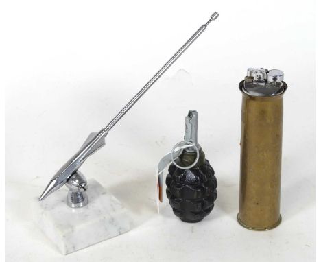 A deactivated WWII Russian RPG anti-tank grenade; together with a 40mm shell case later converted into a lighter; and a chrom