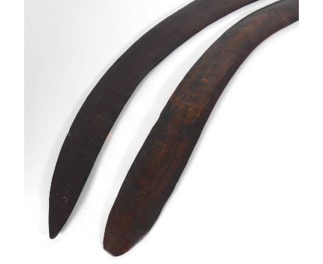 An Aboriginal wooden boomerang, length 72cm; together with one other 