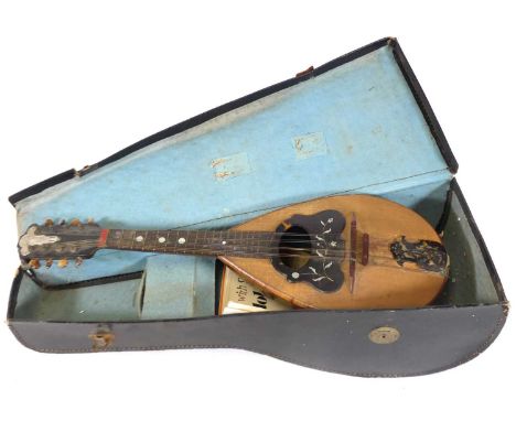 An Italian mandolin having a sectional hardwood back and mother of pearl inlaid simulated tortoise shell decoration, in fitte