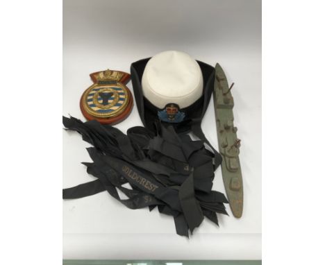 A quantity of naval cap tallies, a WREN hat, scratch-built battleship model and a Matapan boat crest 