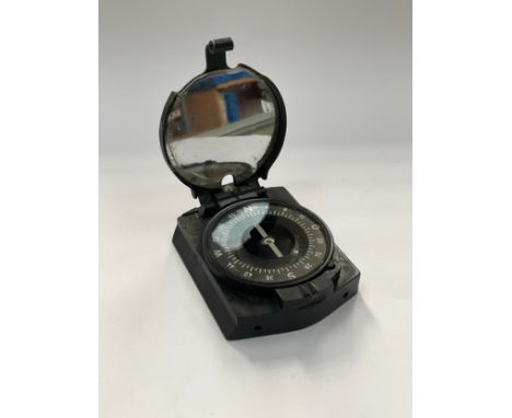 A WWII German marching compass, Bakelite and metal case with mirrored interior, stamped cxn 