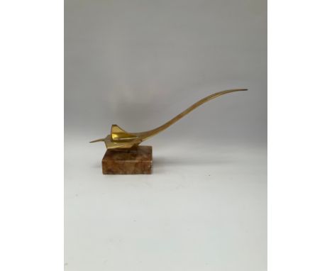 A stylised brass model of Concorde, upon a plinth base 