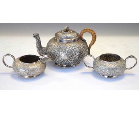 Late 19th century matched white metal tea set in the Kutch manner comprising teapot, sugar bowl and milk jug, teapot 12.5cm h