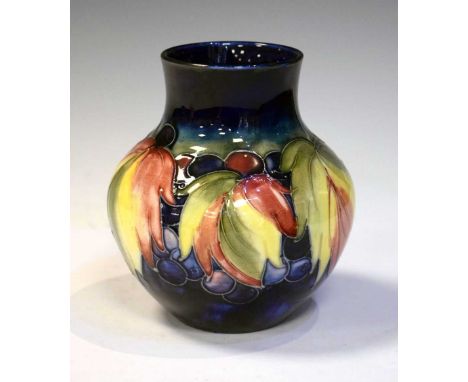 William Moorcroft pottery vase tube-lined in the 'Leaf and Berry' pattern, painted and impressed signature, Potter to H.M. th