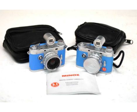 Two Minox Digital Classic 5.1 cameras in blue.