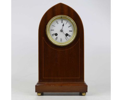 An Edwardian mahogany and pearwood strung lancet shaped mantel clock, having an enamelled dial with Roman numerals and twin w