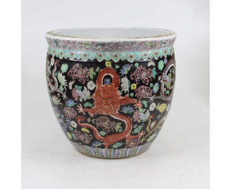 A Chinese pottery jardiniere in the Famille Noir pattern, enamel decorated with flowers and dragons, height 27cmStar crack to