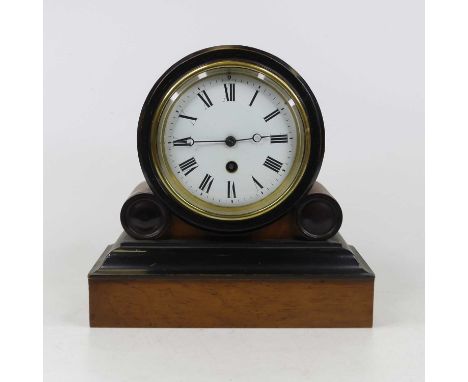 A Victorian walnut and ebonised cased drum head mantel clock, having an enamelled dial with Roman numerals and single winding