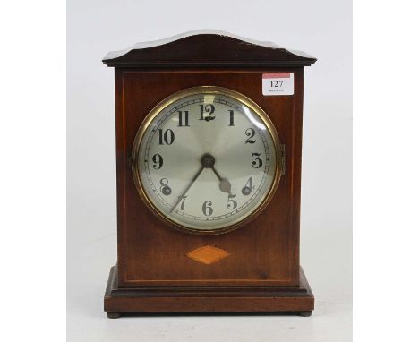 An Edwardian mahogany and inlaid mantel clock, the silvered dial with Arabic numerals and twin winding holes, having an eight