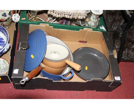 A box of Le Creuset enamel cast iron cookware