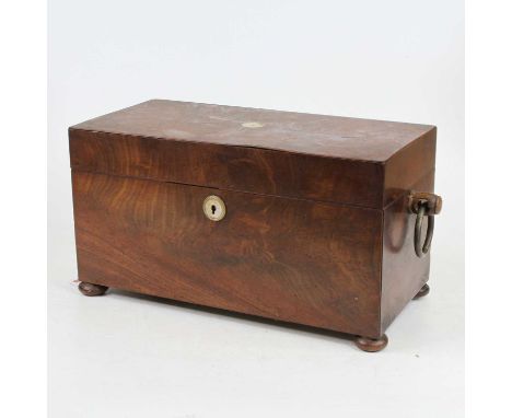 A Regency mahogany tea caddy of rectangular shape, the lid inlaid with mother of pearl roundel, lifting to reveal a fitted in