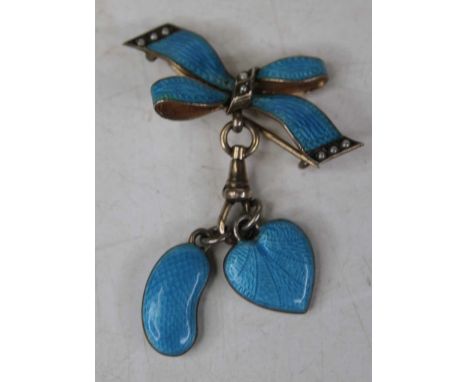 A silver blue enamelled seed pearl set brooch in the form of a ribbon, with two suspended enamelled charmsIntact and looks to