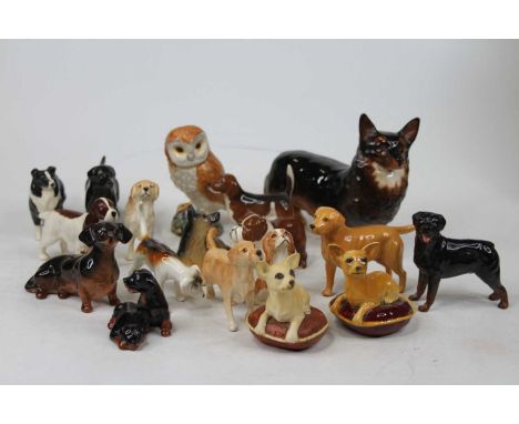 A collection of Beswick animal figures, primarily dogs, largest height 14cmOne dog with hairline crack to underside.Another w