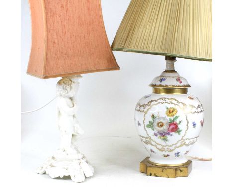 A blanc de chine porcelain  table lamp in the form of a cherub holding a cornucopia, height including shade 51cm, together wi