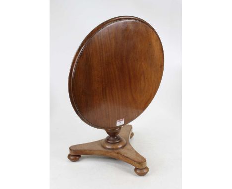 A Victorian mahogany apprentice breakfast table having a hinged circular top on turned baluster column and triform base, term