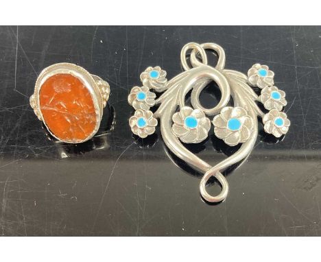 A medieval style white metal cameo ring together with an Art Nouveau style silver and blue enamel set flower head pendant (2)