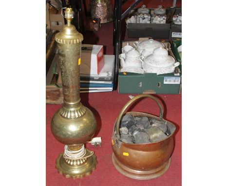 A large Eastern style brass lamp, having a tapered cylindrical neck to a bulbous base and domed foot; together with a copper 