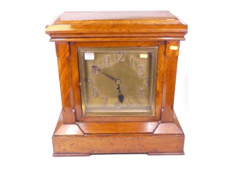 A late Victorian walnut cased mantel clock of architectural form, the copper dial with applied Arabic numerals and single win