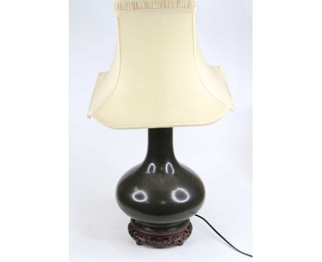 A Chinese green glazed stoneware vase of squat bulbous form with slender neck, converted to a table lamp, mounted on a hardwo