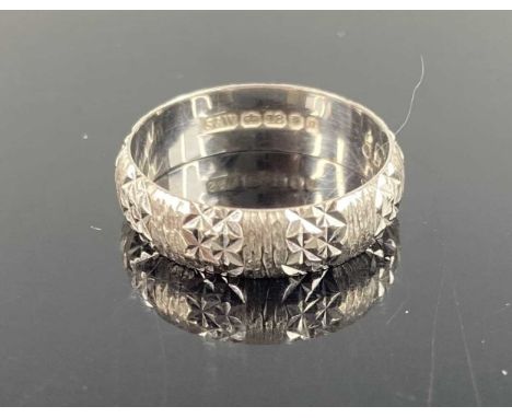An 18ct bright cut white gold wedding band, sponsor S&amp;W, 3.5g, size K