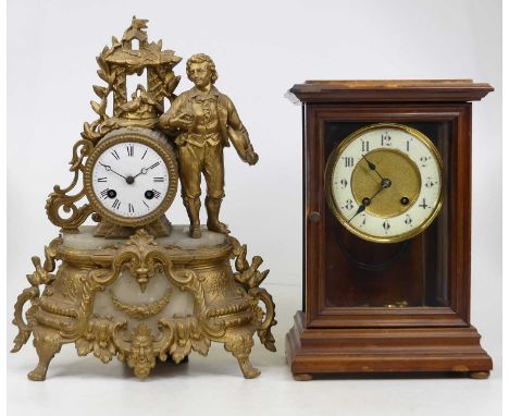 A Victorian glazed walnut cased mantel clock, having an enamelled chapter ring with Roman numerals and twin winding holes, h.