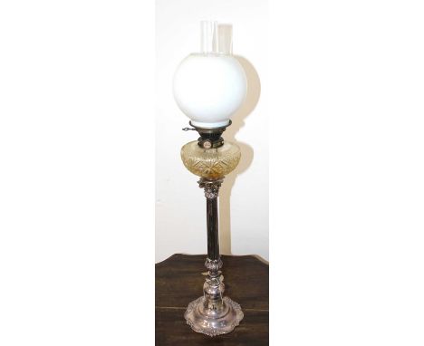 A Victorian oil lamp having a clear glass chimney, associated opaline glass shade, on Hinks No. 2 bayonet fit burner, cut cle