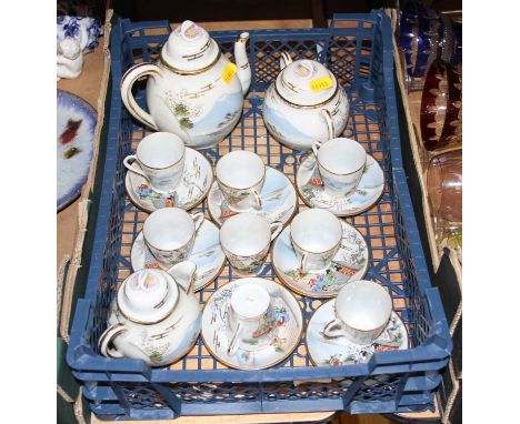 A Japanese eggshell porcelain eight place setting tea service, enamel decorated with figures and flowers before Mount Fuji