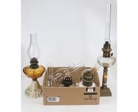 A Victorian oil lamp having an Eveready &amp; Co burner on clear glass reservoir under polychrome painted cast iron base, hei