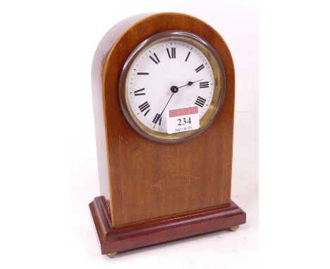 An Edwardian mahogany and pearwood strung dome top mantel clock, the painted dial with Roman numerals, height 22cm