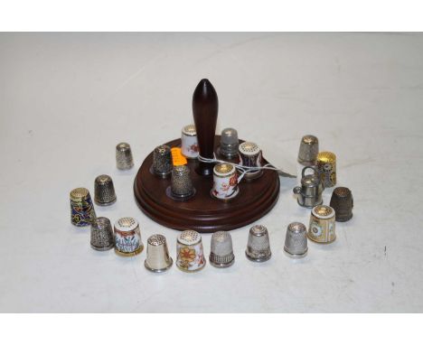 A collection of various porcelain enamel and silver thimbles