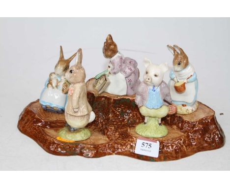 A collection of five Beswick Beatrix Potter character figures, shown upon a tree stump display stand, largest height 11cm