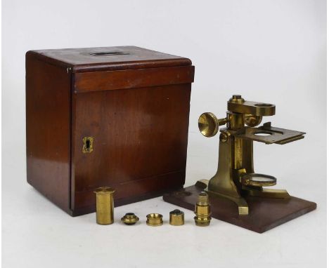 A 19th century monocular microscope base by Baker, the mechanical stage above adjustable mirror, a Y shaped foot, signed 'Bak