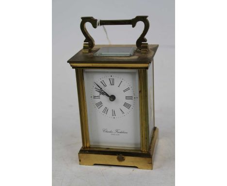 A Charles Frodsham lacquered brass carriage clock, the enamel dial showing Roman numerals, having visible platform escapement