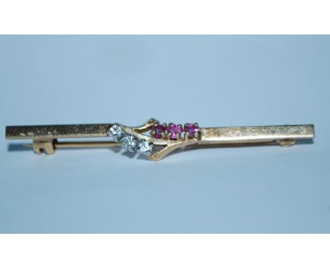 A hallmarked 9ct gold bar brooch set with white and ruby stones having a roller clasp. Hallmarked London brooch and 375 crown