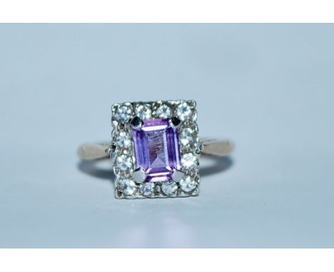 A hallmarked 9ct gold purple sapphire and white stone cluster ring. Hallmarked Birmingham. Size K. Weight 3.8g.