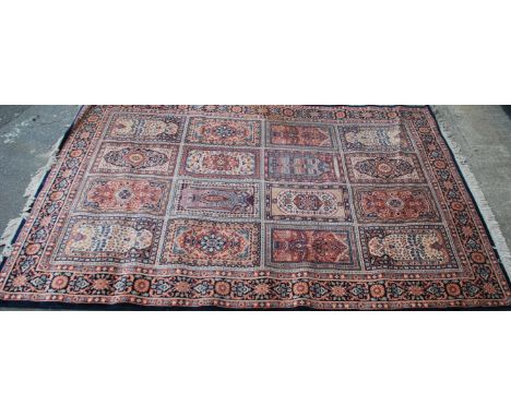 A large 20th century Persian / Islamic floor carpet rug having geometric medallions and spandrels. Measures 290cms by 200cms.