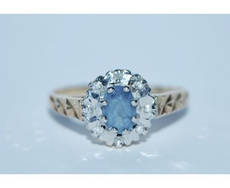 A hallmarked 9ct gold and diamond cluster ring with central blue stone. Hallmarked Birmingham. Size M.&nbsp;